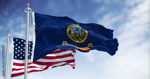 The Idaho state flag waving along with the national flag of the United States