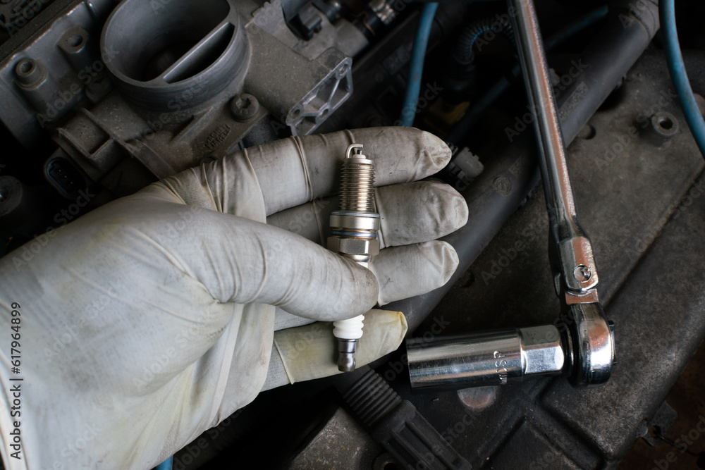 car maintenance, replacement of spark plugs in internal combustion engine, in the workshop during replacement, maintenance of spark plugs in the heart of the engine. repair with tools, ratchet. car maintenance, replacement of spark plugs in internal combustion engine, in the workshop during replacement, maintenance of spark plugs in the heart of the engine. repair with tools, ratchet.