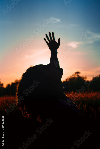 silhouette of beautiful young woman at sunset