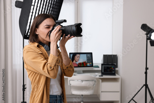 Professional photographer taking picture in modern photo studio photo