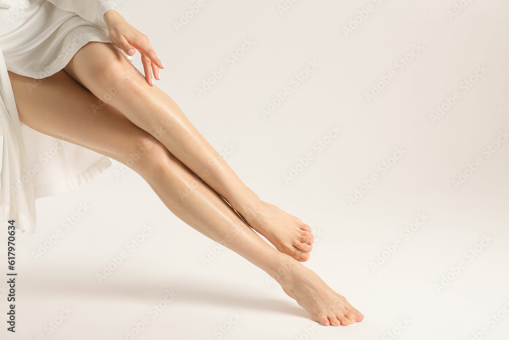 Woman with beautiful smooth legs on white background, closeup. Space for text