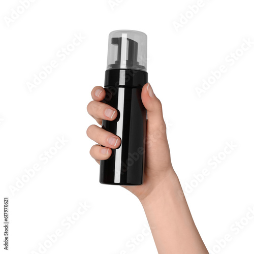 Woman holding bottle of face cleansing product on white background, closeup