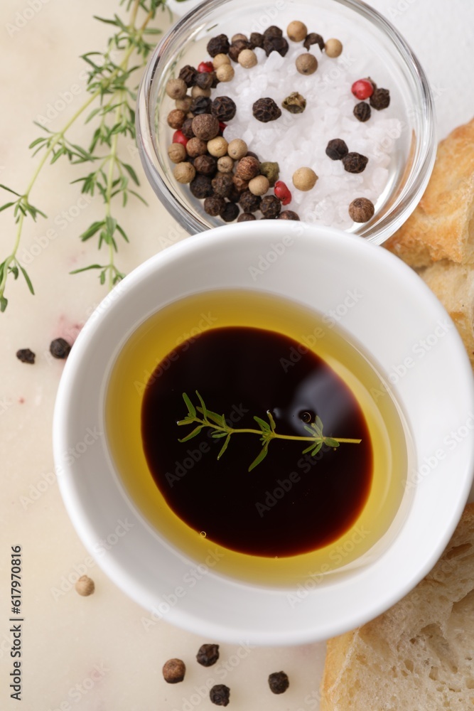 Bowl of organic balsamic vinegar with oil, spices and bread slices on beige table, flat lay Bowl of organic balsamic vinegar with oil, spices and bread slices on beige table, flat lay