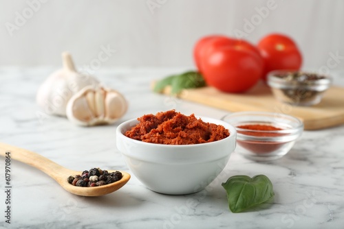 Red curry paste and ingredients on white marble table