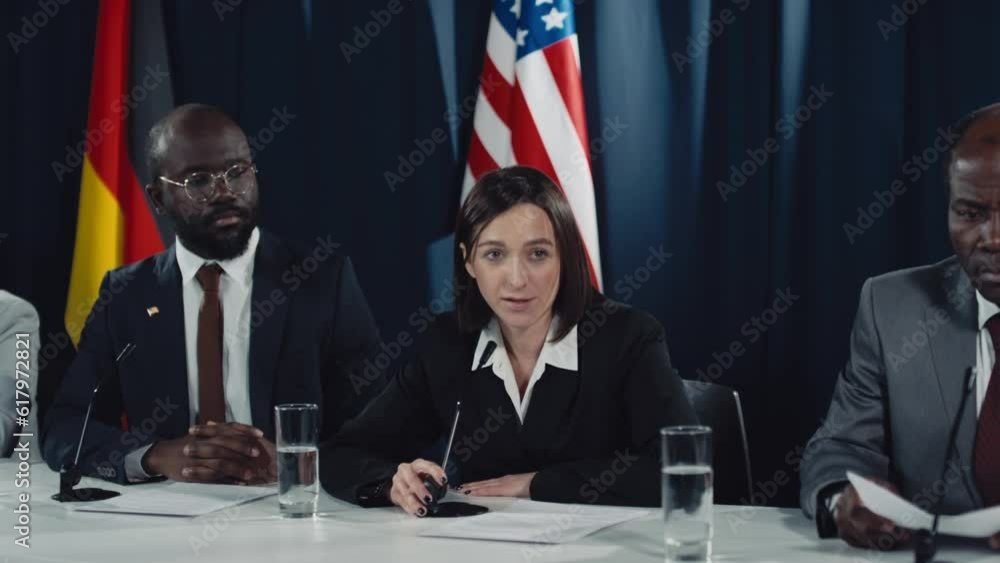 Medium shot of young Caucasian female politician with short brown hair ...