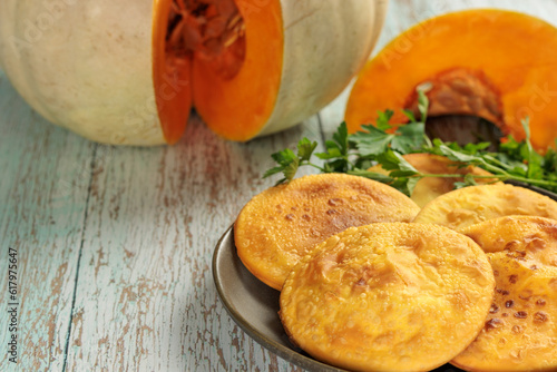 Εκτύπωση καμβά Sopaipillas in a round dish on a wooden table, pumpkin or squash cut in the background and parsley, close-up