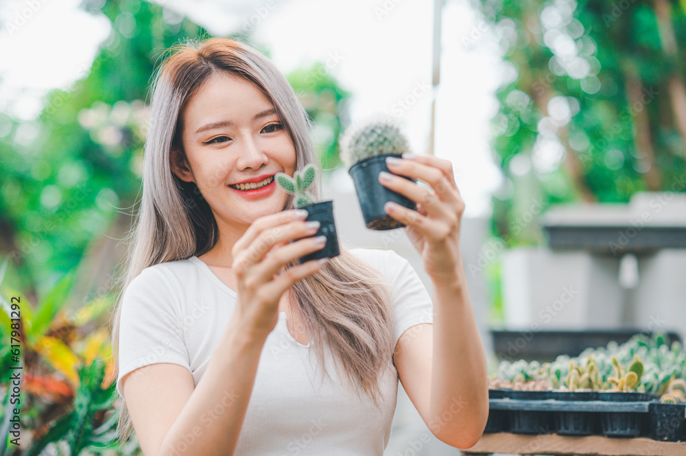 Young women doing hobbies taking care of plants, watering, shoveling flowers. In the garden during the break from work Young women doing hobbies taking care of plants, watering, shoveling flowers. In the garden during the break from work