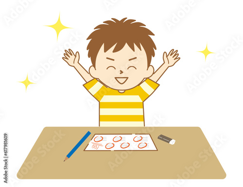 テストで100点をとって万歳をして喜ぶ男の子