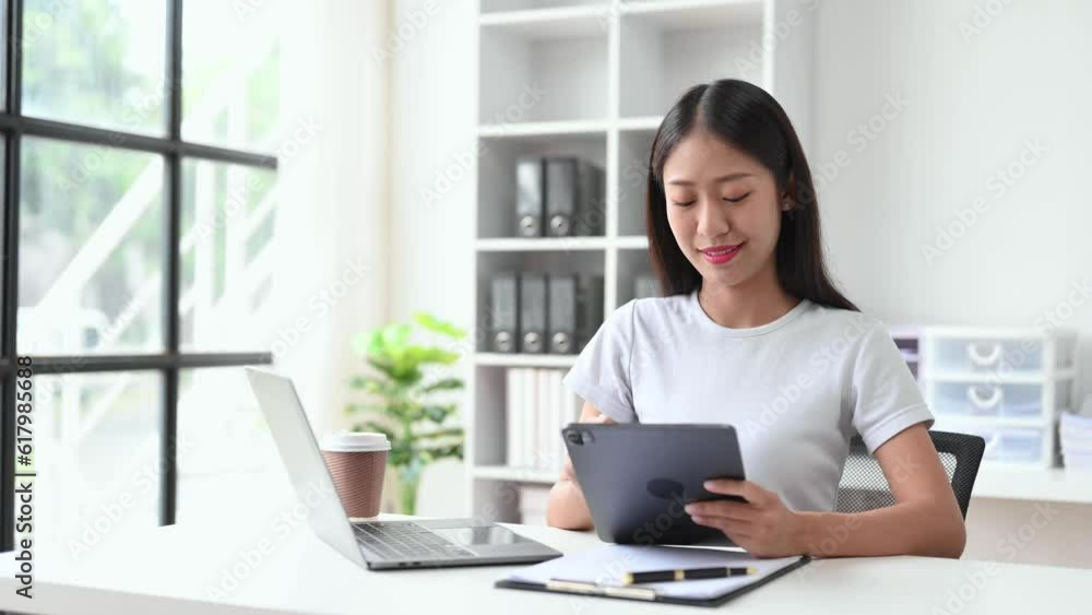 Business woman using tablet and laptop for doing math finance on an office desk, tax, report, accounting, statistics, and analytical research concept in office Business woman using tablet and laptop for doing math finance on an office desk, tax, report, accounting, statistics, and analytical research concept in office