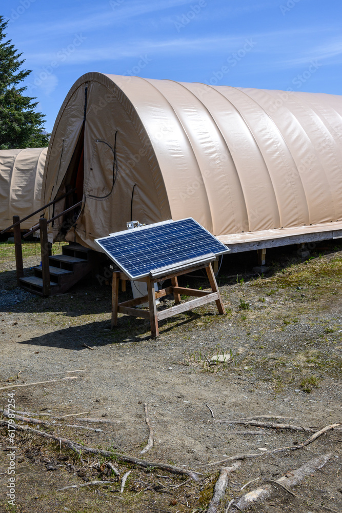 Remote ecotourism camp with weatherproof tents and green power supplied by solar panels
Remote ecotourism camp with weatherproof tents and green power supplied by solar panels