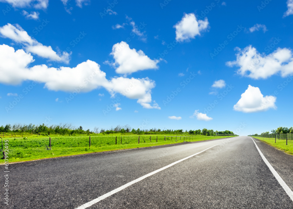 abstract empty road in summer, blue sky, white clouds, highway or speedway in rural countryside created with generative ai technology