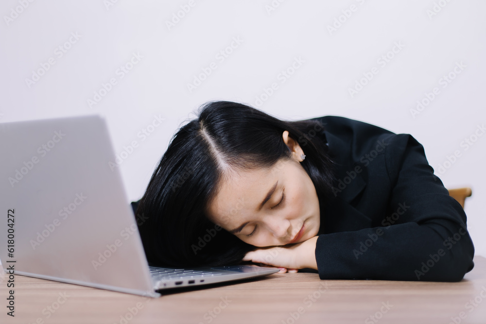 Asian woman working in office,young business woman stressed from work overload with a lot file on the desk Asian woman working in office,young business woman stressed from work overload with a lot file on the desk