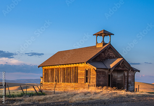 Old Abandoned One Room Schoolhouse glowing in the late afternoon light.  Wasco County, Oregon photo