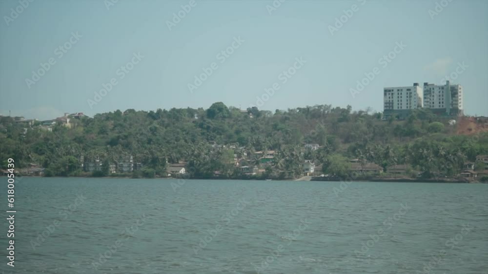 A coastal area of the Indian Ocean on the bay - Houses and buildings on the riverside in India A coastal area of the Indian Ocean on the bay - Houses and buildings on the riverside in India