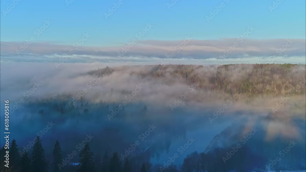 Bird's eye view of mountains with pine forests under a cloud cover. Bird's eye view of mountains with pine forests under a cloud cover.