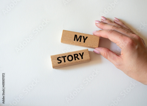 My story symbol. Wooden blocks with words My story Beautiful white background. Businessman hand. Business and My story concept. Copy space.