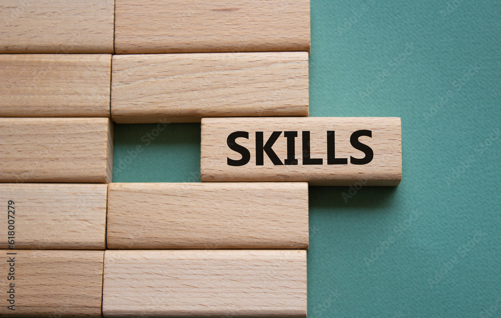 Skills symbol. Concept word Skills on wooden blocks. Beautiful grey green background. Business and Skills concept. Copy space. Skills symbol. Concept word Skills on wooden blocks. Beautiful grey green background. Business and Skills concept. Copy space.