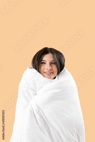 Smiling young woman wrapped...