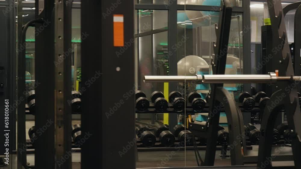 Equipment assortment, Personal trainers, Home gyms. Gym houses diverse set dumbbells and high-standard fitness equipment. Equipment assortment, Personal trainers, Home gyms. Gym houses diverse set dumbbells and high-standard fitness equipment.