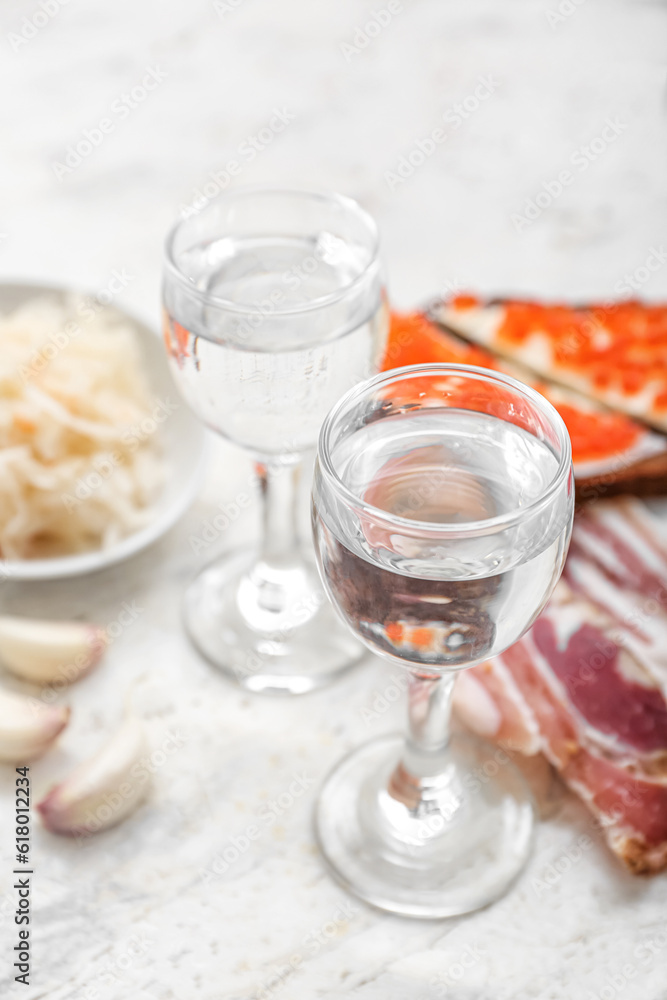 Shots with cold vodka on light background Shots with cold vodka on light background