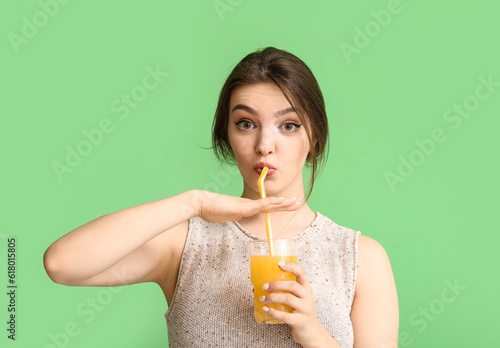 Young woman drinking orange...