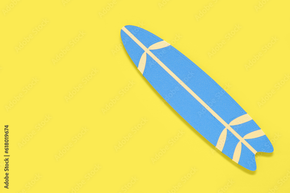 Mini surfboard on yellow background Mini surfboard on yellow background