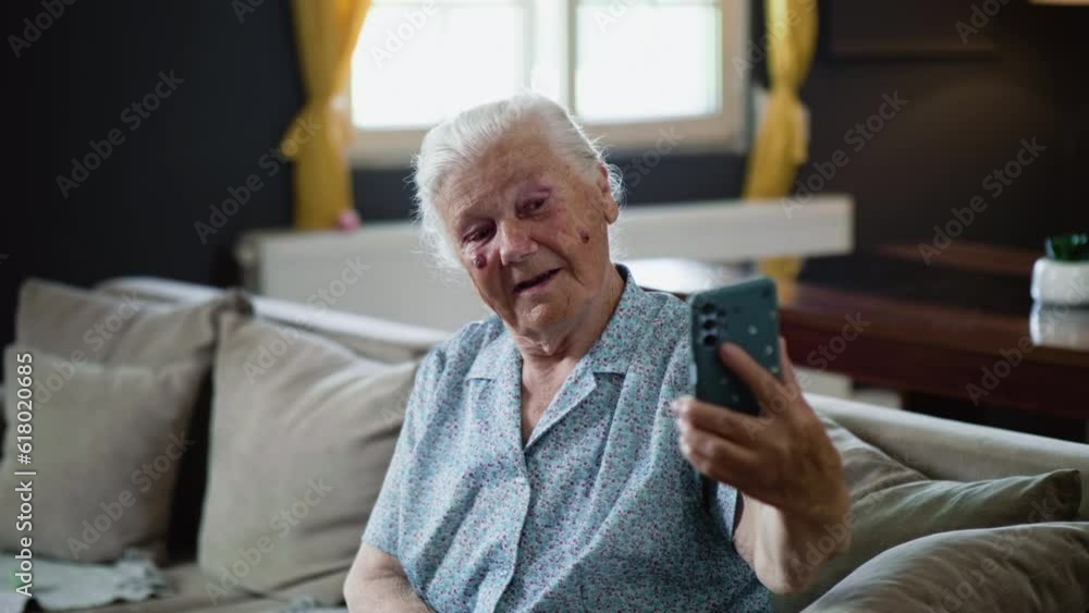 Old woman grandmother in the 80s is having fun taking selfies using her phone at home Old woman grandmother in the 80s is having fun taking selfies using her phone at home