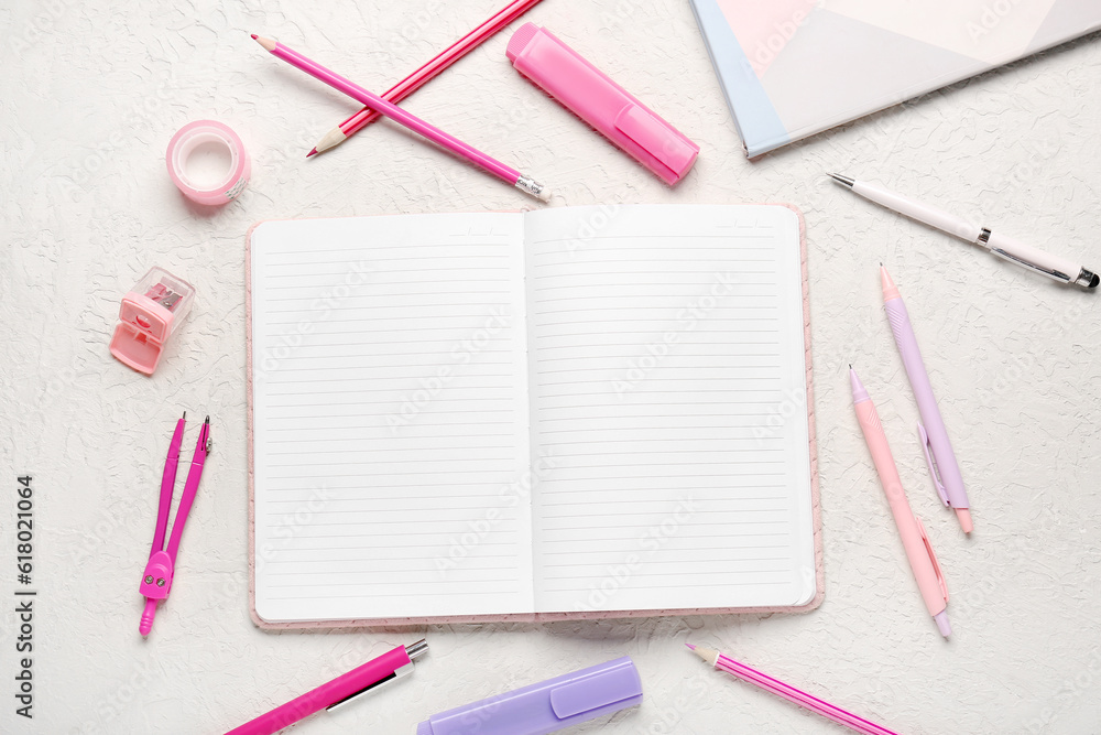 Notebooks with different stationery on grunge white background Notebooks with different stationery on grunge white background