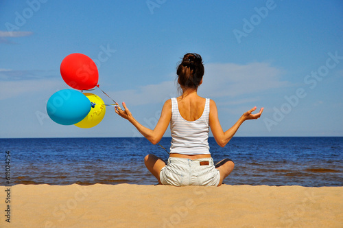 A girl meditating on the seashore.