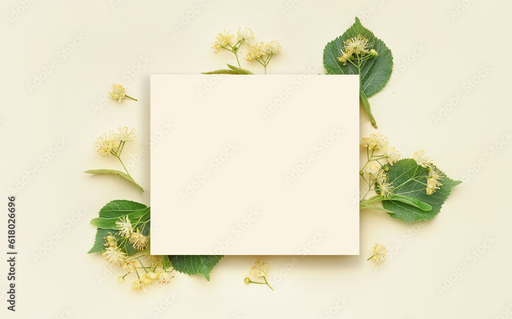 Composition with blank card and aromatic linden flowers on color background