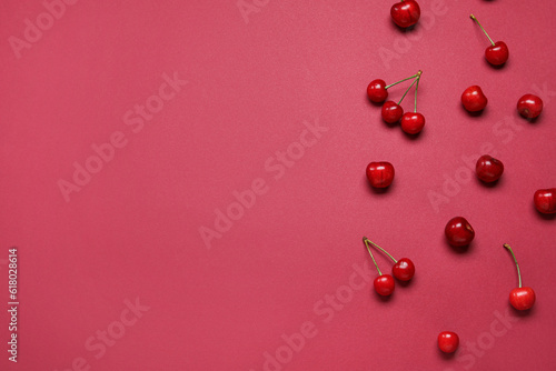 Many sweet cherries on red background