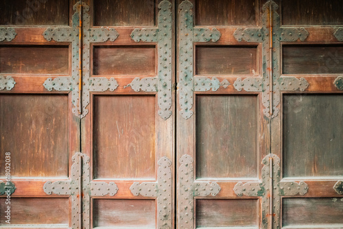 Background texture of a massive medieval metal studded wooden door in a castle as copy space.