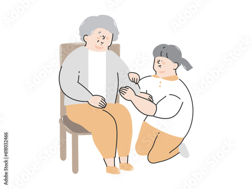 シニア女性の着替えの介助をする介護スタッフ