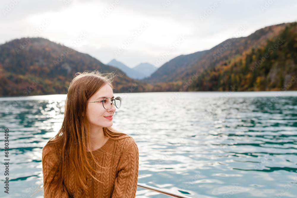 young woman on vacation near an alpine lake in austria
