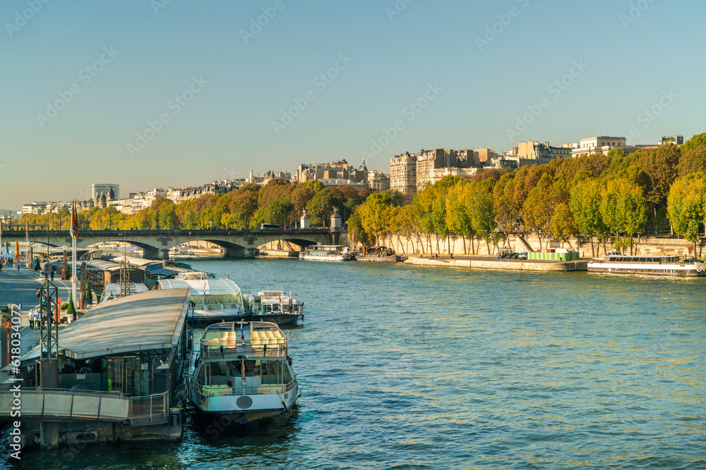 Fototapeta premium Seine river with boats and cityscape of Paris, France