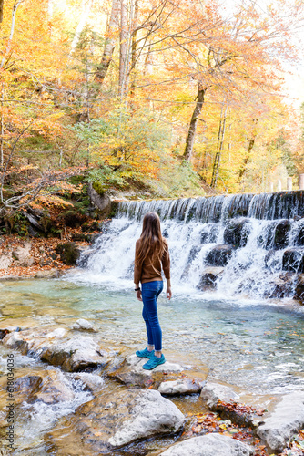 young woman tourist near a waterfall in the Austrian forests