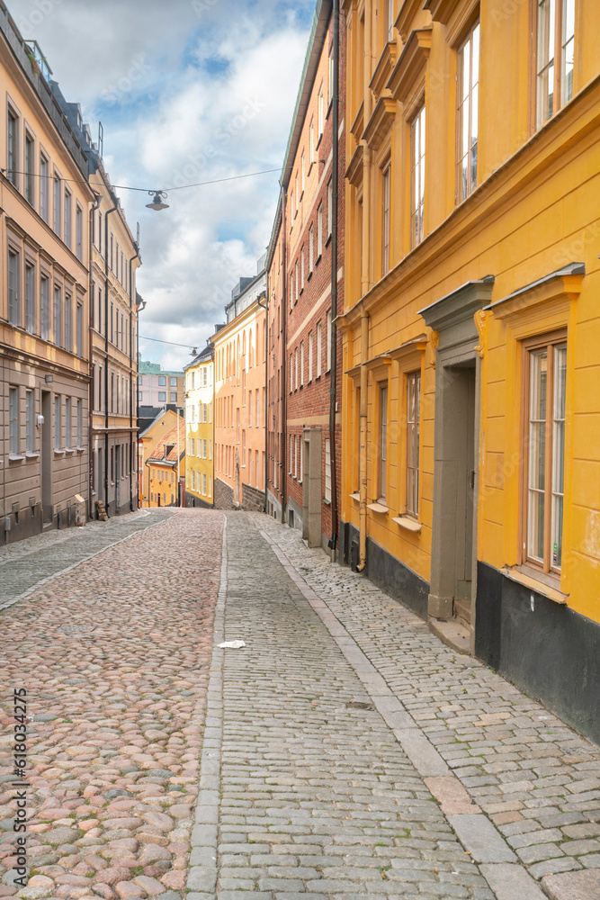 Narrow alley in the old town with yellow buildings, Stockholm, Sweden