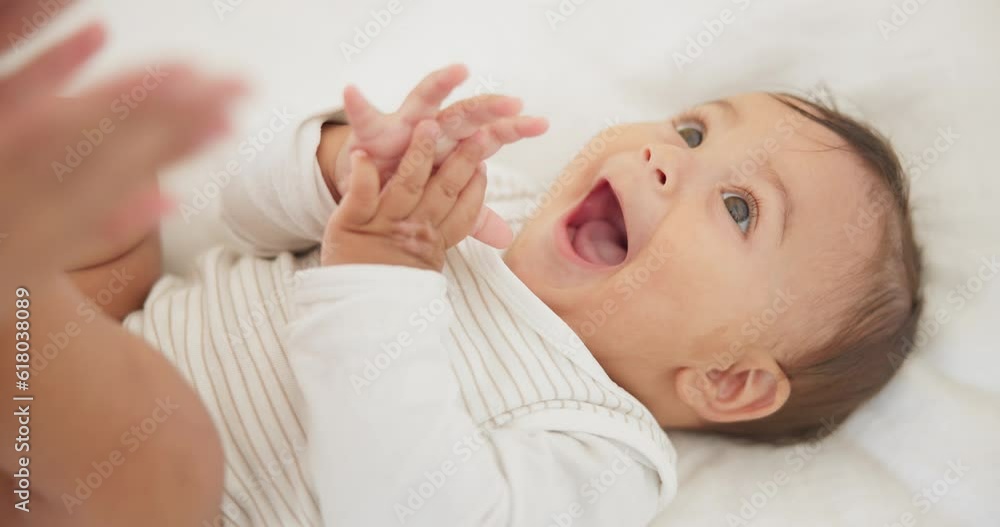 Infant baby, clapping hands and bed with parent, care or learning with smile, love or childhood development. Young happy kid, nursery or bedroom with teaching, applause or excited face in family home Infant baby, clapping hands and bed with parent, care or learning with smile, love or childhood development. Young happy kid, nursery or bedroom with teaching, applause or excited face in family home