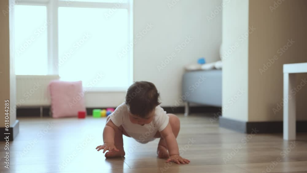 Beautiful, little, happy, smiling baby, toddler making first steps, walking at home on daytime. Smart, delightful kid. Concept of childhood, emotions, care and health, life and birth, motherhood, ad Beautiful, little, happy, smiling baby, toddler making first steps, walking at home on daytime. Smart, delightful kid. Concept of childhood, emotions, care and health, life and birth, motherhood, ad