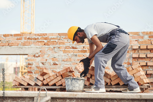 Focused on work. Handsome Indian man is on the construction site