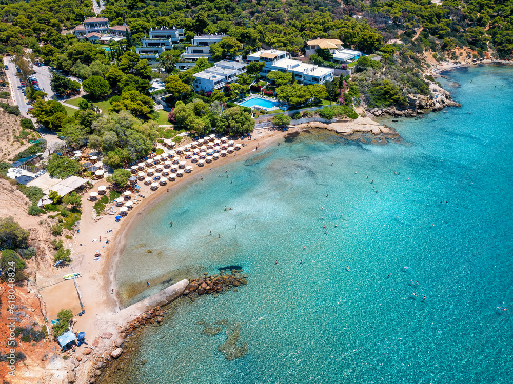 Aerial view of the beautiful Nirides - Zen beach at the bay of Vouliagmeni, Athens, Greece, with shining turquoise sea