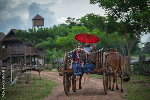 Thai women ride a cart as a vehicle.The journey of Thai people in the past used ox wagons as a means of transportation.