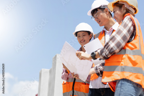 In the Industrial Engineering Facility: Diverse Group of Engineers, Technicians, and Specialists on a Meeting, Have Discussion, Analyse Engine Design Technical Drafts that are Lying on the Table