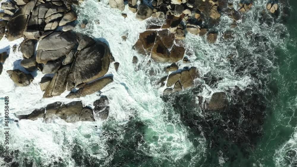 Aerial top view video of sea waves crashing on the rocky shore Aerial top view video of sea waves crashing on the rocky shore