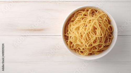 a white bowl filled with cooked spaghetti noodles.