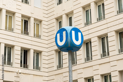 A subway U sign in Vienna in Austria on the background of a building.