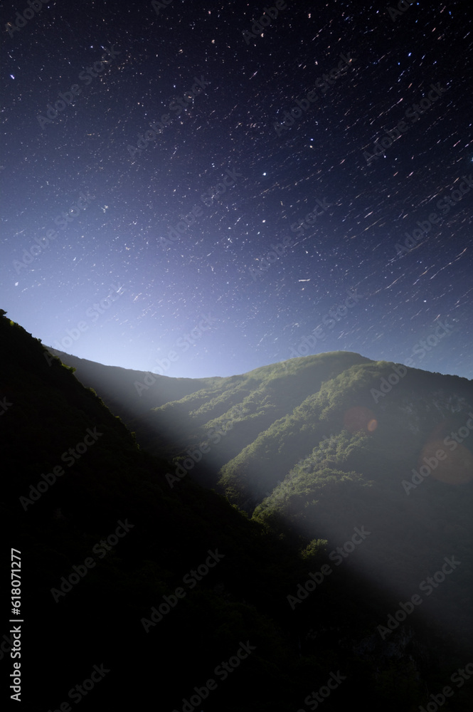 Moon light over the mountain with starry night sky