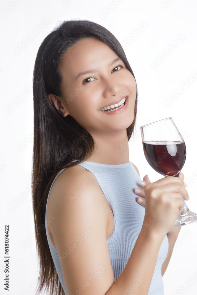 Beautiful Asian woman smiling and holding glass of red wine Beautiful Asian woman smiling and holding glass of red wine