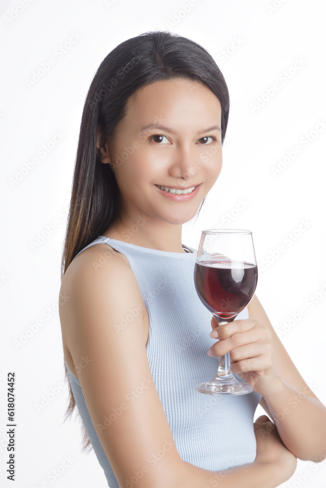 Beautiful Asian woman smiling and holding glass of red wine Beautiful Asian woman smiling and holding glass of red wine