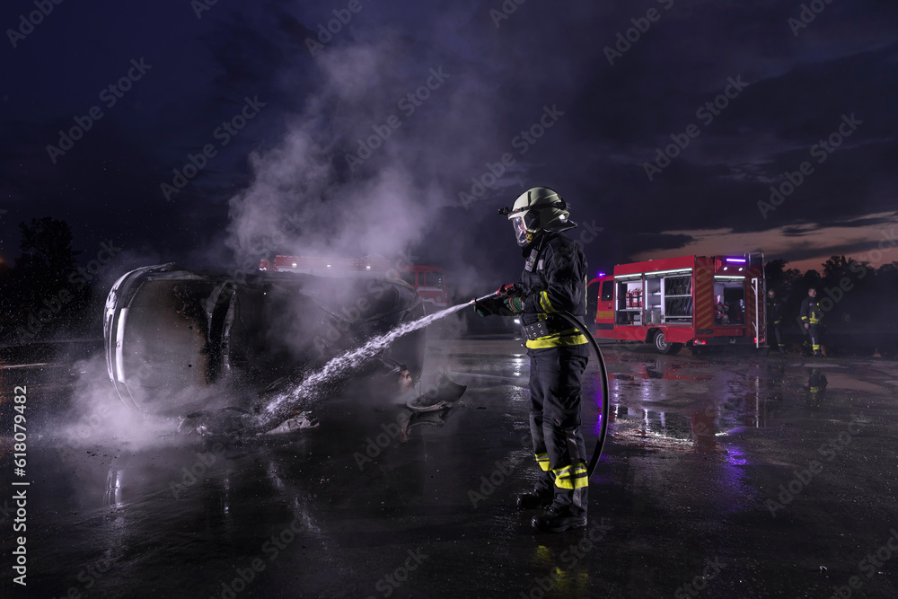 Firefighters fight the fire flame to control fire not to spreading out. Firefighter industrial and public safety concept. Traffic or car accident rescue and help action. Firefighters fight the fire flame to control fire not to spreading out. Firefighter industrial and public safety concept. Traffic or car accident rescue and help action.